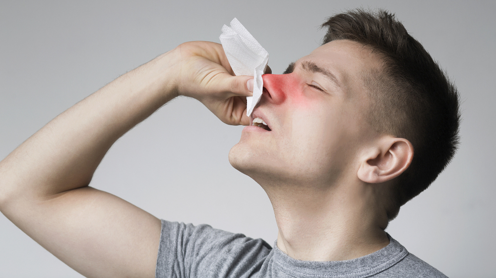 Man with nosebleed